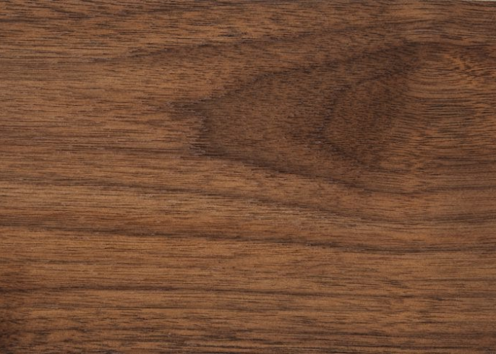 Dark walnut wood sample displaying rich chocolate brown color and straight grain for luxury furniture